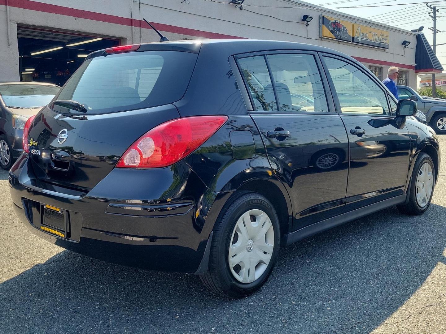 2010 Super Black - KH3 /Charcoal - G Nissan Versa 1.8 S (3N1BC1CP3AL) with an 1.8L DOHC 16-valve CVTCS I4 engine engine, located at 50 Eastern Blvd., Essex, MD, 21221, (410) 686-3444, 39.304367, -76.484947 - Meet the 2010 Nissan Versa 1.8 S 5DR HB I4 Auto 1.8 S, a sophisticated blend of performance, efficiency, and style. Powered by a 1.8L DOHC 16-valve CVTCS I4 engine, this dynamo exudes confidence on every road exerting unrivaled horsepower and torque. Its Super Black - KH3 exterior is a testament to - Photo#3