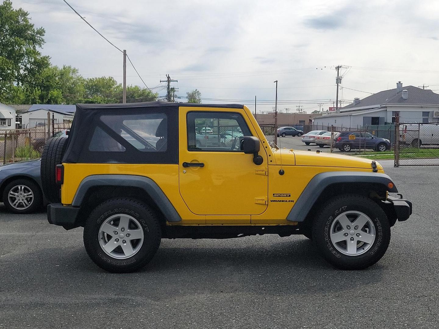 2011 Detonator Yellow Clear Coat - PYB /Black Interior - A7X9 Jeep Wrangler Sport (1J4AA2D13BL) with an 3.8L SMPI V6 ENGINE engine, located at 50 Eastern Blvd., Essex, MD, 21221, (410) 686-3444, 39.304367, -76.484947 - Experience the true joy of driving with this rugged 2011 Jeep Wrangler Sport 4WD 2dr Sport, finished in stunning Detonator Yellow Clear Coat. This classic off-road icon pairs beautifully with a sleek black interior, offering a striking contrast that is guaranteed to turn heads. Under the hood you'll - Photo#4