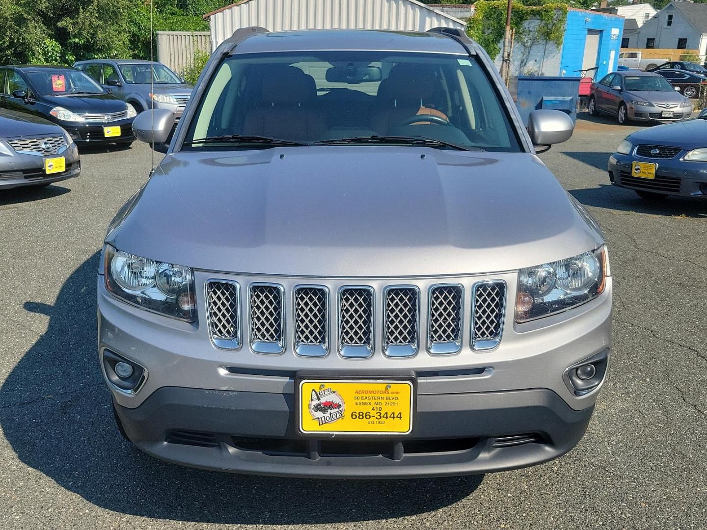 2016 Billet Silver Metallic Clearcoat - PSC /Saddle Tan/Dk Slate Gray - SLVT Jeep Compass High Altitude Edition (1C4NJDEB1GD) with an ENGINE: 2.4L I4 DOHC 16V DUAL VVT engine, located at 50 Eastern Blvd., Essex, MD, 21221, (410) 686-3444, 39.304367, -76.484947 - Presenting the sophisticated 2016 Jeep Compass High Altitude Edition. Clad in a stunning billet silver metallic clearcoat exterior, this 4WD, 4-door SUV captures attention on every journey. The interior is equally impressive, showcasing a luxurious saddle tan/dark slate gray color scheme. Under the - Photo#1