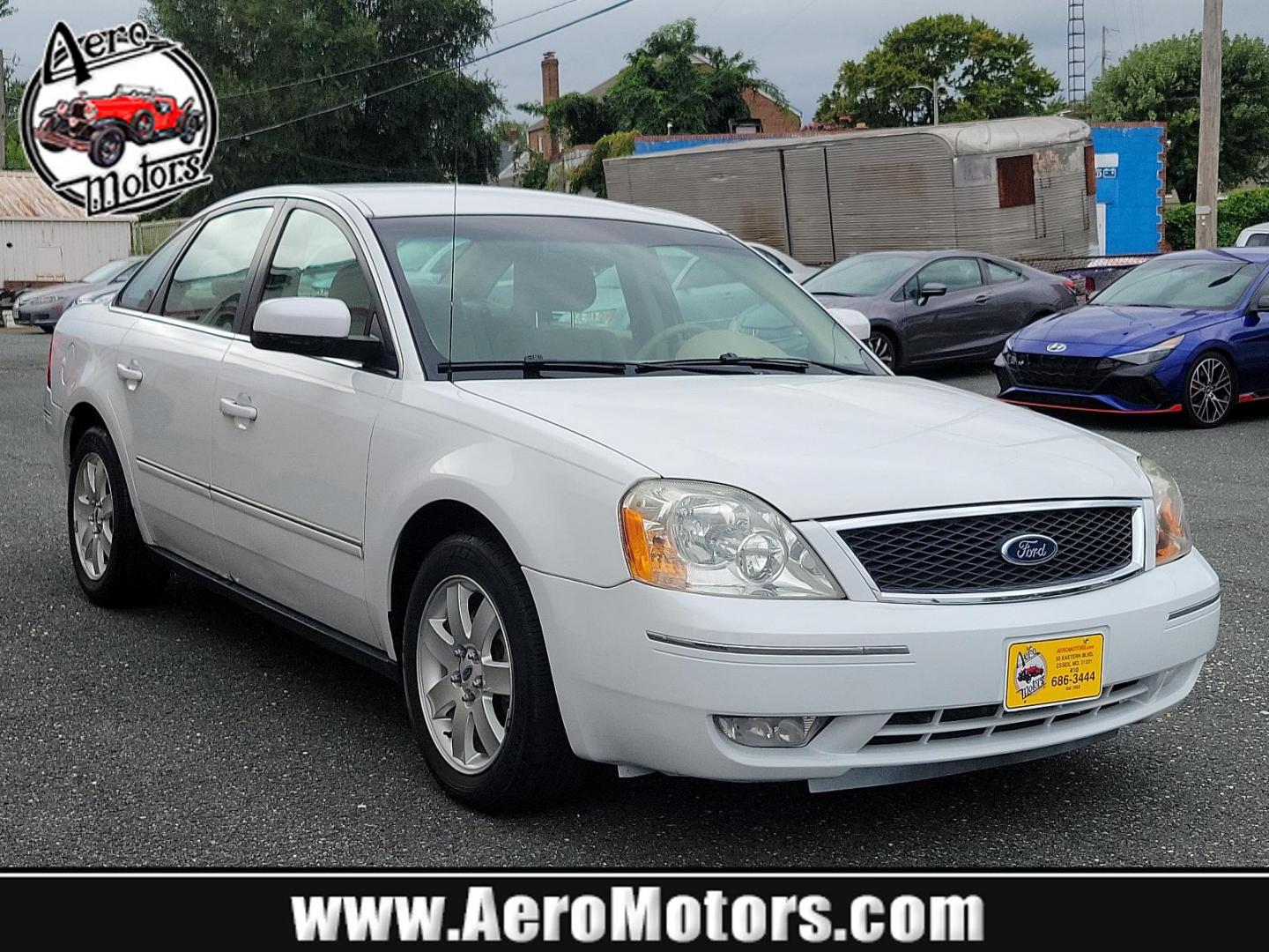 2005 Oxford White - YZ /Pebble Tan - 7 Ford Five Hundred SEL (1FAFP24175G) with an 3.0L DOHC SMPI 24-VALVE V6 DURATEC ENGINE engine, located at 50 Eastern Blvd., Essex, MD, 21221, (410) 686-3444, 39.304367, -76.484947 - Experience the perfect blend of comfort and performance with this 2005 Ford Five Hundred SEL 4dr sedan. The pristine white exterior displays a modern charm while its 3.0L DOHC SMPI 24-valve V6 Duratec engine ensures reliable performance. The Four-Door SEL model combines practicality with style, perf - Photo#0