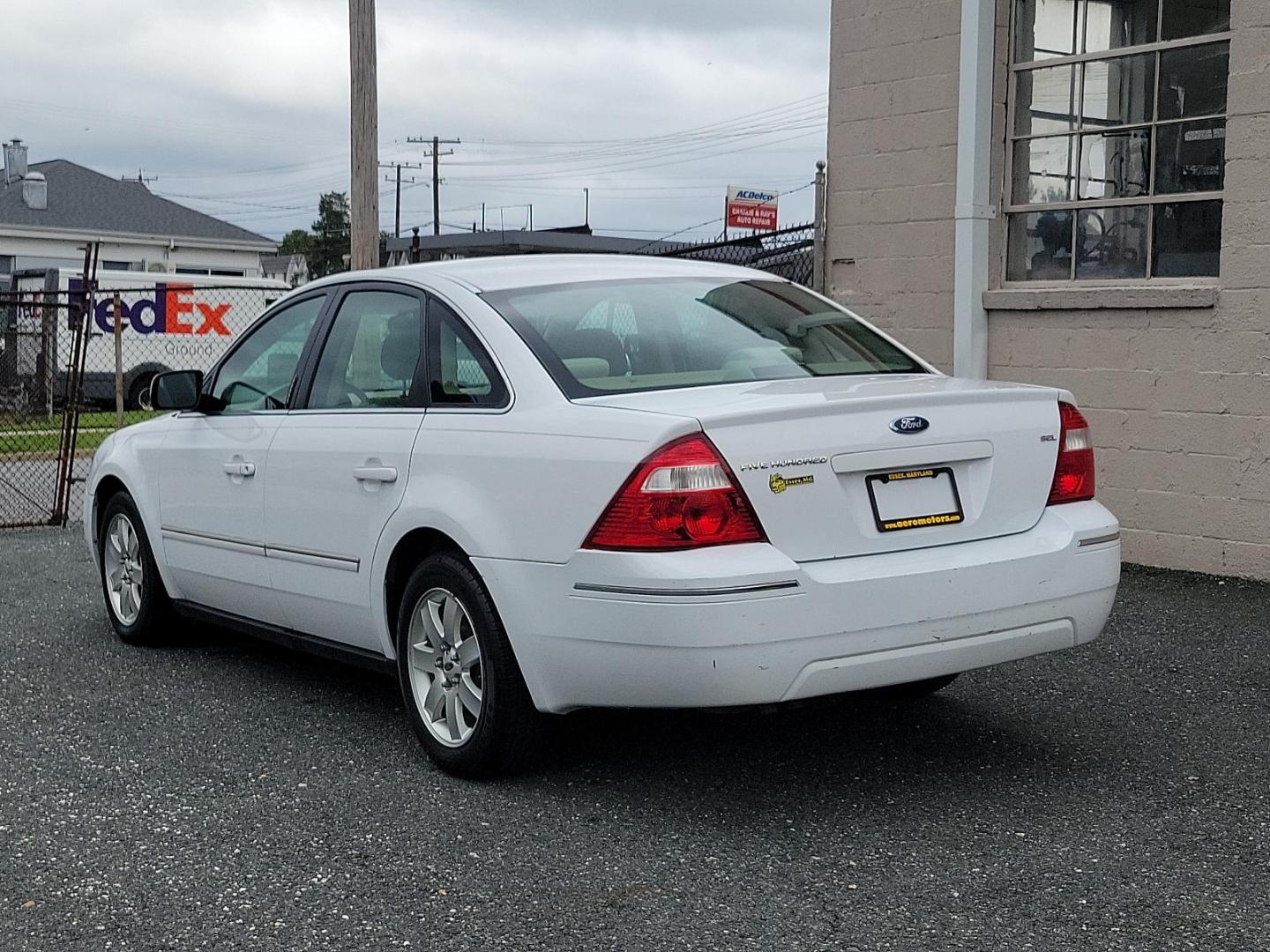 2005 Oxford White - YZ /Pebble Tan - 7 Ford Five Hundred SEL (1FAFP24175G) with an 3.0L DOHC SMPI 24-VALVE V6 DURATEC ENGINE engine, located at 50 Eastern Blvd., Essex, MD, 21221, (410) 686-3444, 39.304367, -76.484947 - Experience the perfect blend of comfort and performance with this 2005 Ford Five Hundred SEL 4dr sedan. The pristine white exterior displays a modern charm while its 3.0L DOHC SMPI 24-valve V6 Duratec engine ensures reliable performance. The Four-Door SEL model combines practicality with style, perf - Photo#3