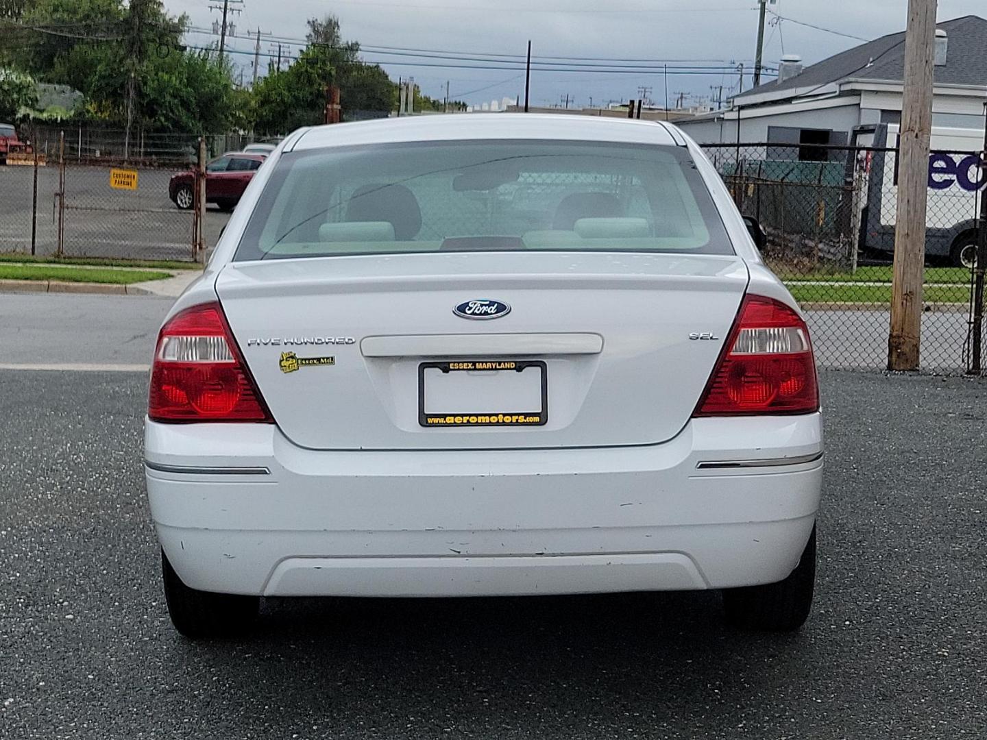 2005 Oxford White - YZ /Pebble Tan - 7 Ford Five Hundred SEL (1FAFP24175G) with an 3.0L DOHC SMPI 24-VALVE V6 DURATEC ENGINE engine, located at 50 Eastern Blvd., Essex, MD, 21221, (410) 686-3444, 39.304367, -76.484947 - Experience the perfect blend of comfort and performance with this 2005 Ford Five Hundred SEL 4dr sedan. The pristine white exterior displays a modern charm while its 3.0L DOHC SMPI 24-valve V6 Duratec engine ensures reliable performance. The Four-Door SEL model combines practicality with style, perf - Photo#4