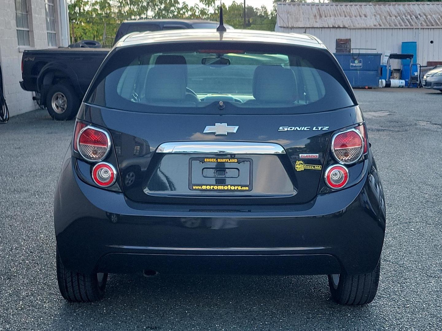 2014 Black Granite Metallic - GAR /Dark Pewter/Dark Titanium - ADP Chevrolet Sonic LTZ (1G1JE6SB3E4) with an ENGINE, ECOTEC TURBO 1.4L VARIABLE VALVE TIMING DOHC 4-CYLINDER SEQUENTIAL MFI engine, located at 50 Eastern Blvd., Essex, MD, 21221, (410) 686-3444, 39.304367, -76.484947 - Discover the outstanding 2014 Chevrolet Sonic LTZ 5-Door Hatchback Auto LTZ - an embodiment of power and style. Coated in a sleek Black Granite Metallic exterior coupled with a sophisticated Dark Pewter/Dark Titanium interior, this vehicle combines aesthetics with quality. Under the hood, nestled pe - Photo#4