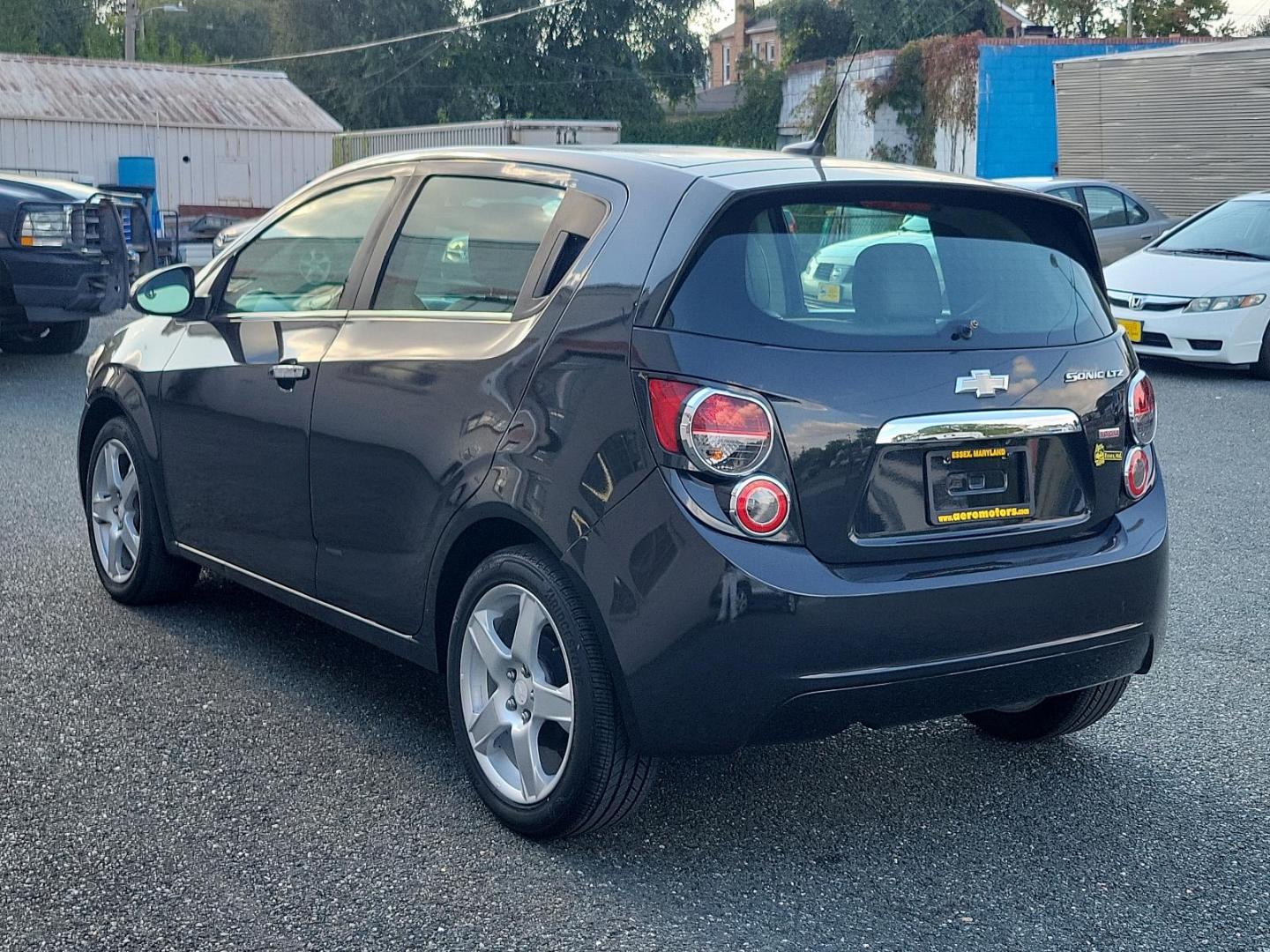 2014 Black Granite Metallic - GAR /Dark Pewter/Dark Titanium - ADP Chevrolet Sonic LTZ (1G1JE6SB3E4) with an ENGINE, ECOTEC TURBO 1.4L VARIABLE VALVE TIMING DOHC 4-CYLINDER SEQUENTIAL MFI engine, located at 50 Eastern Blvd., Essex, MD, 21221, (410) 686-3444, 39.304367, -76.484947 - Discover the outstanding 2014 Chevrolet Sonic LTZ 5-Door Hatchback Auto LTZ - an embodiment of power and style. Coated in a sleek Black Granite Metallic exterior coupled with a sophisticated Dark Pewter/Dark Titanium interior, this vehicle combines aesthetics with quality. Under the hood, nestled pe - Photo#5