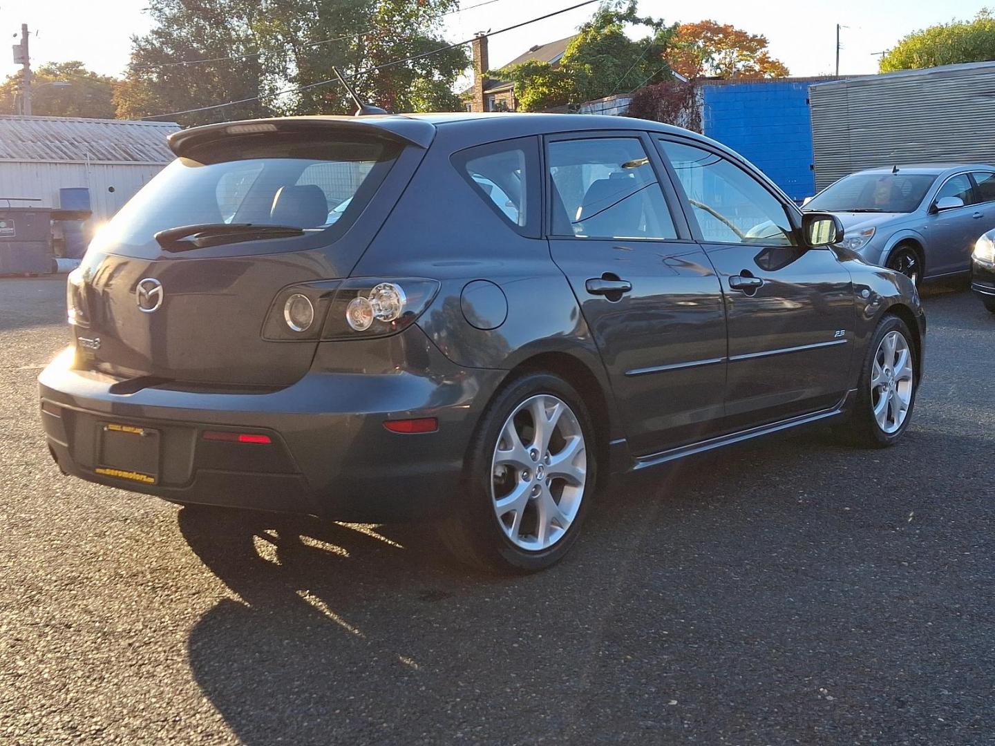 2009 Metropolitan Gray Mica - 36C /Black - BR6 Mazda MAZDA3 s Grand Touring (JM1BK343191) with an 2.3L DOHC MPFI 16-valve I4 engine w/variable valve timing (VVT), balance shafts engine, located at 50 Eastern Blvd., Essex, MD, 21221, (410) 686-3444, 39.304367, -76.484947 - Feast your eyes on this well-maintained 2009 Mazda MAZDA3 s Grand Touring, an epitome of design and functionality. This 5-door hatchback comes with an elegant metropolitan gray mica exterior complemented by a plush black interior. Under the hood, it boasts a powerful, sophisticated 2.3L DOHC MPFI 16 - Photo#3