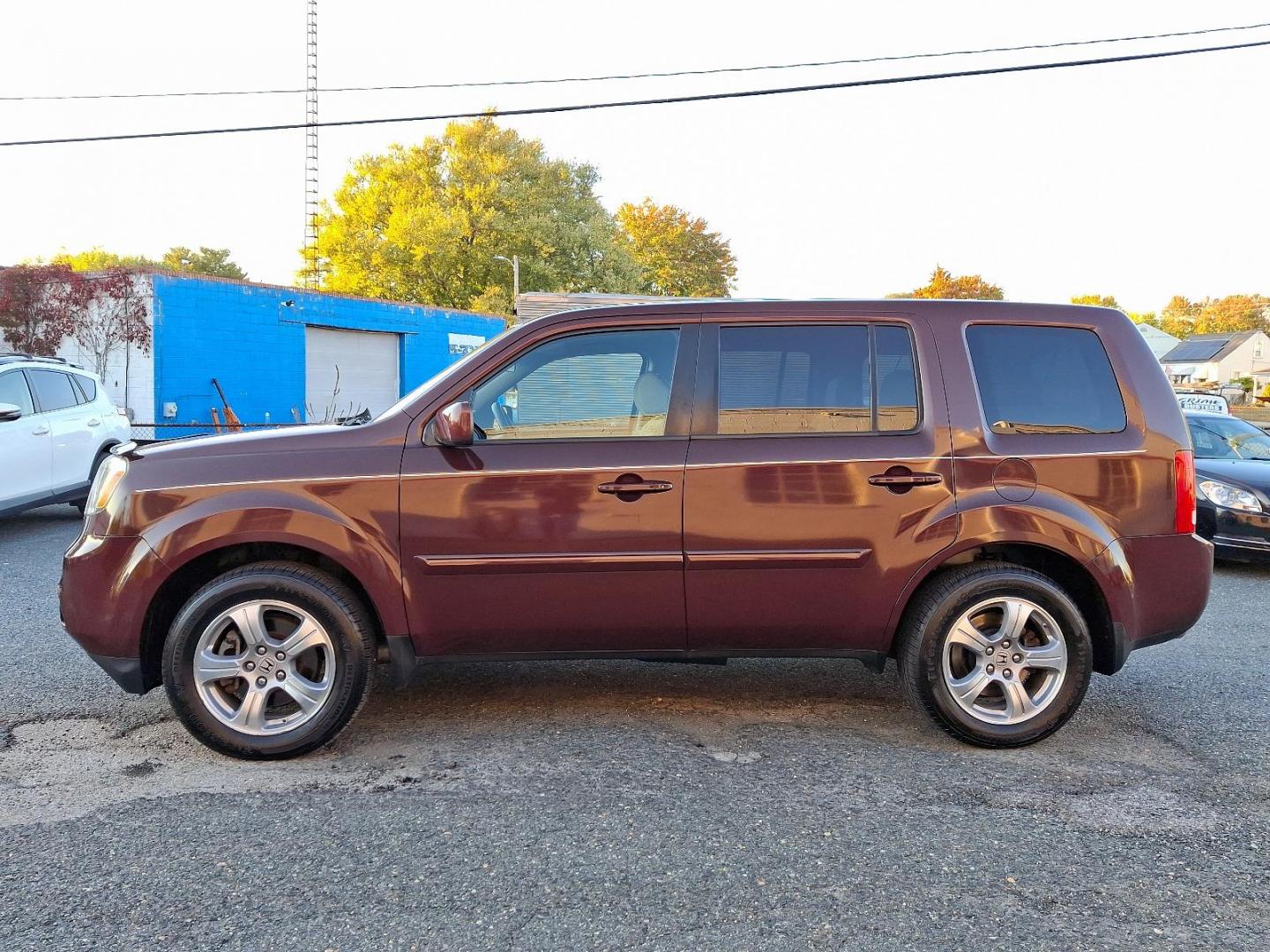 2012 Dark Cherry Pearl II - RX /Beige - BE Honda Pilot EX (5FNYF4H42CB) with an 3.5L SOHC MPFI 24-valve i-VTEC V6 engine engine, located at 50 Eastern Blvd., Essex, MD, 21221, (410) 686-3444, 39.304367, -76.484947 - Presenting a stunning 2012 Honda Pilot EX 4WD 4DR EX cloaked in a captivating maroon color for a unique style statement. This spectacular ride seats seven, ensuring comfort and space for family and friends. At its heart, the Pilot runs on a robust 3.5L SOHC MPFI 24-valve i-VTEC V6 engine, combining - Photo#6