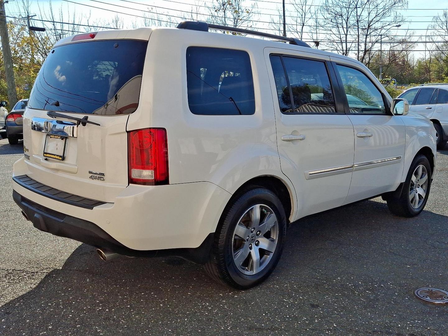 2014 White Diamond Pearl - WA /Black - BK Honda Pilot Touring (5FNYF4H97EB) with an Engine: 3.5L V6 24-Valve SOHC i-VTEC engine, located at 50 Eastern Blvd., Essex, MD, 21221, (410) 686-3444, 39.304367, -76.484947 - Experience the perfect blend of style, comfort, and versatility with the 2014 Honda Pilot Touring 4WD. This sophisticated SUV is finished in a pristine white exterior, exuding elegance and modernity. Powered by a robust 3.5L V6 24-valve SOHC i-VTEC engine, the Pilot delivers a smooth and responsive - Photo#3